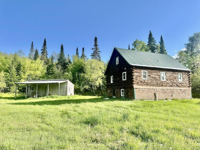 3342 E Hill Rd, Wolcott, VT 05680 - view of side of property featuring log exterior, metal roof, and a lawn
