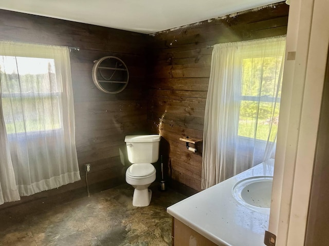 3342 E Hill Rd, Wolcott, VT 05680 - bathroom featuring wood walls, toilet, and vanity