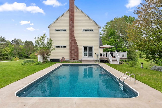 1465 N Main St, Bakersfield, VT 05441 - rear view of property with a wooden deck, a lawn, a chimney, and an outdoor pool