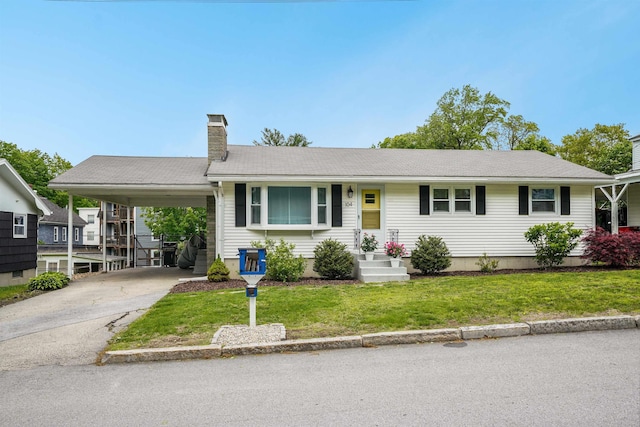 104 Lodge St, Manchester, NH 03104 - single story home featuring a chimney, an attached carport, concrete driveway, and a front yard