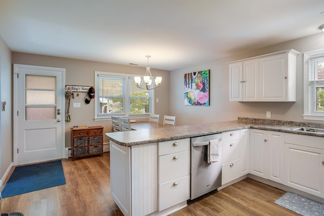 104 Lodge St, Manchester, NH 03104 - kitchen with a peninsula, dishwasher, light wood finished floors, and a chandelier