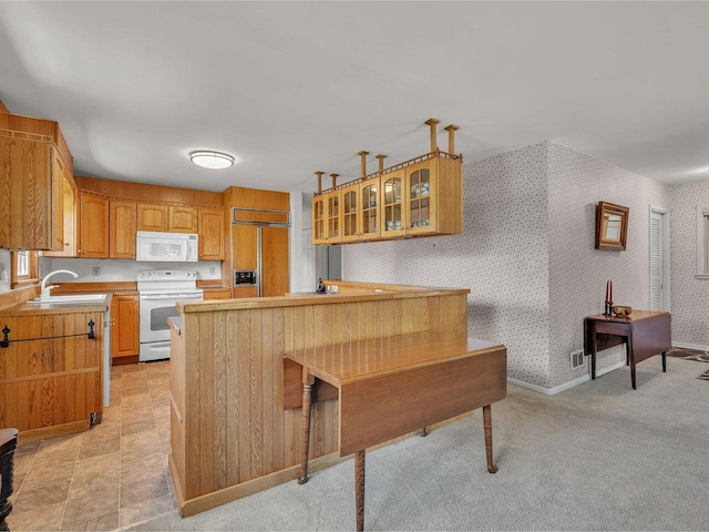 154 Birchcliff Pkwy, Burlington, VT 05041 - kitchen featuring white appliances, a sink, glass insert cabinets, light countertops, and wallpapered walls