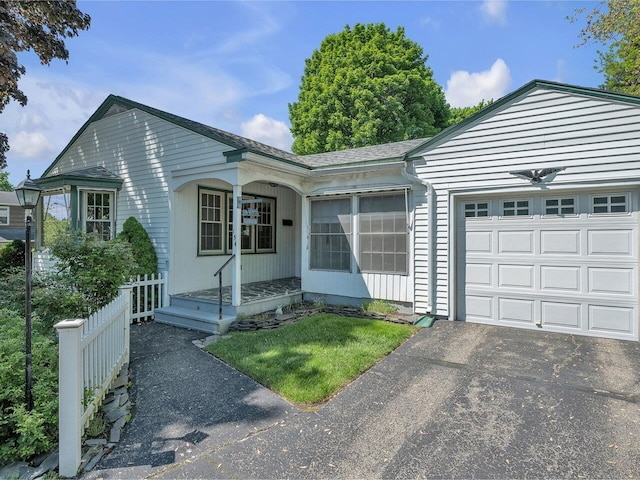 154 Birchcliff Pkwy, Burlington, VT 05041 - single story home featuring an attached garage, asphalt driveway, covered porch, and a shingled roof