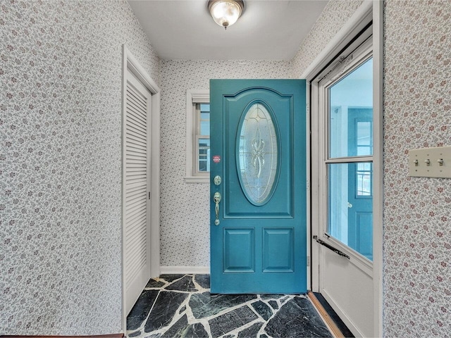 154 Birchcliff Pkwy, Burlington, VT 05041 - entrance foyer featuring wallpapered walls, dark stone finish flooring, and baseboards