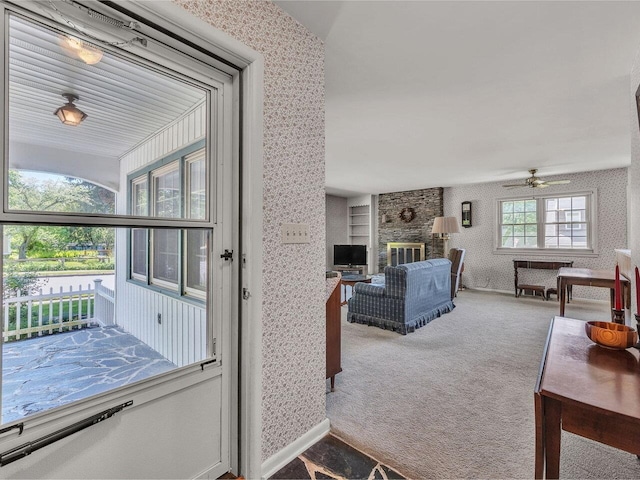 154 Birchcliff Pkwy, Burlington, VT 05041 - entryway with wallpapered walls, ceiling fan, carpet floors, and a fireplace