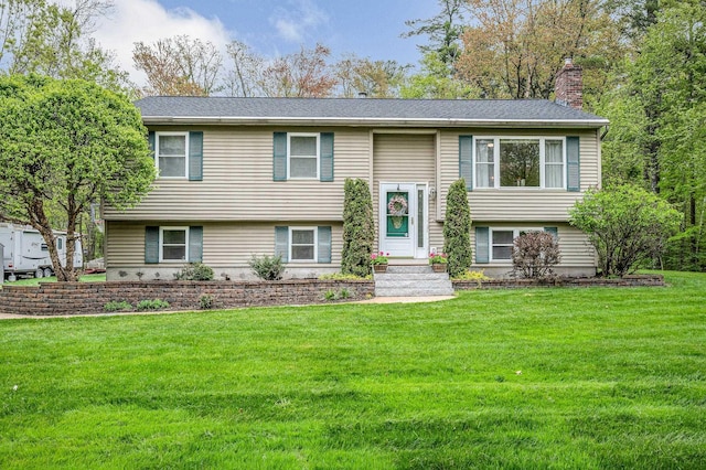 28 Hardy Rd, Londonderry, NH 03053 - raised ranch featuring a chimney and a front yard