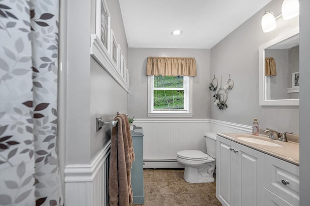 28 Hardy Rd, Londonderry, NH 03053 - bathroom with a wainscoted wall, a baseboard radiator, toilet, vanity, and curtained shower