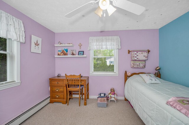 28 Hardy Rd, Londonderry, NH 03053 - carpeted bedroom featuring a baseboard heating unit, ceiling fan, and baseboards