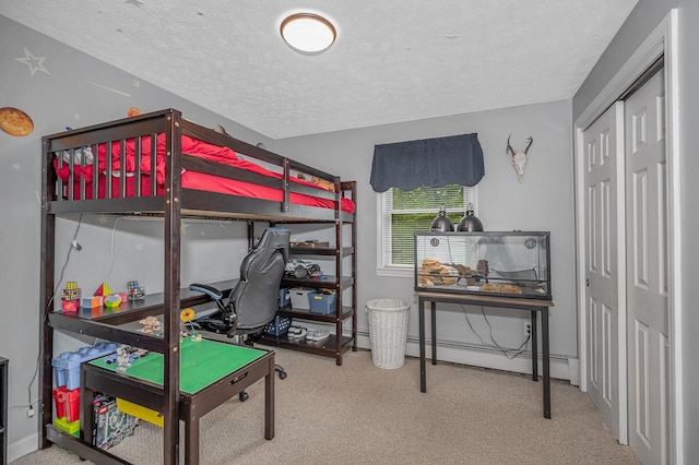 28 Hardy Rd, Londonderry, NH 03053 - carpeted bedroom featuring a textured ceiling, baseboard heating, and a closet