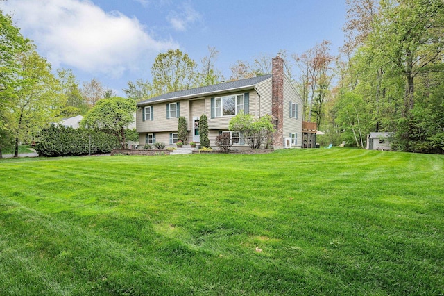 28 Hardy Rd, Londonderry, NH 03053 - raised ranch with a chimney and a front yard
