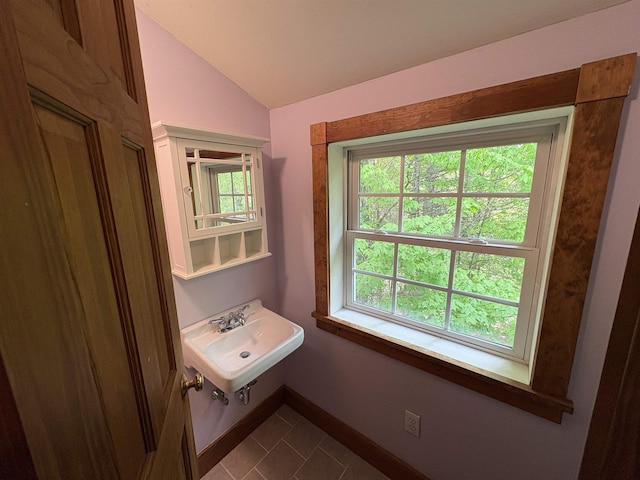 10 Youngs Rd, East Haven, VT 05837 - bathroom featuring a sink, tile patterned floors, vaulted ceiling, and baseboards