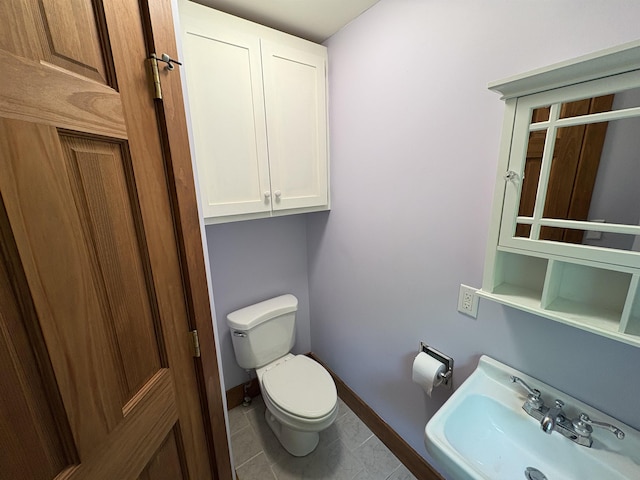 10 Youngs Rd, East Haven, VT 05837 - half bathroom featuring a sink, toilet, baseboards, and tile patterned flooring