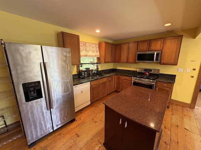 10 Youngs Rd, East Haven, VT 05837 - kitchen featuring stainless steel appliances, light wood-style floors, brown cabinetry, recessed lighting, and a center island