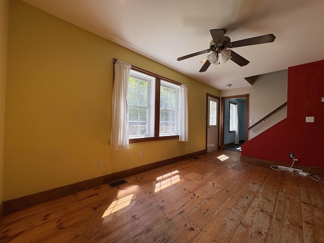 10 Youngs Rd, East Haven, VT 05837 - unfurnished room with hardwood / wood-style floors, baseboards, a ceiling fan, and stairs
