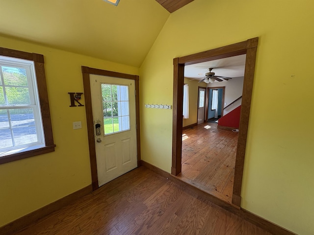 10 Youngs Rd, East Haven, VT 05837 - doorway to outside with dark wood-type flooring, vaulted ceiling, and baseboards