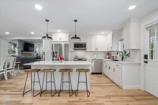 140 S Mast St, Goffstown, NH 03045 - kitchen featuring appliances with stainless steel finishes, a sink, decorative backsplash, white cabinetry, and recessed lighting