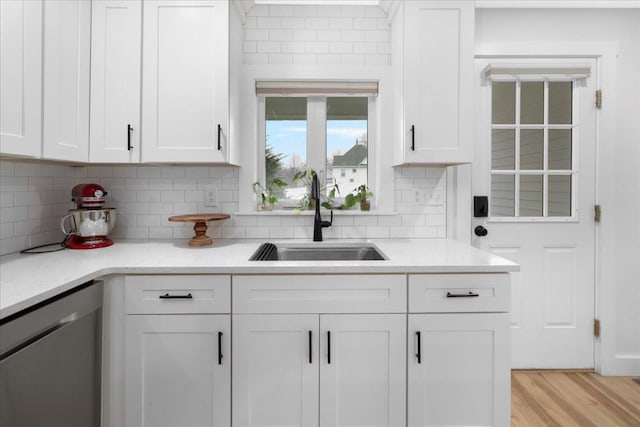 140 S Mast St, Goffstown, NH 03045 - kitchen featuring dishwasher, a sink, white cabinets, and light countertops
