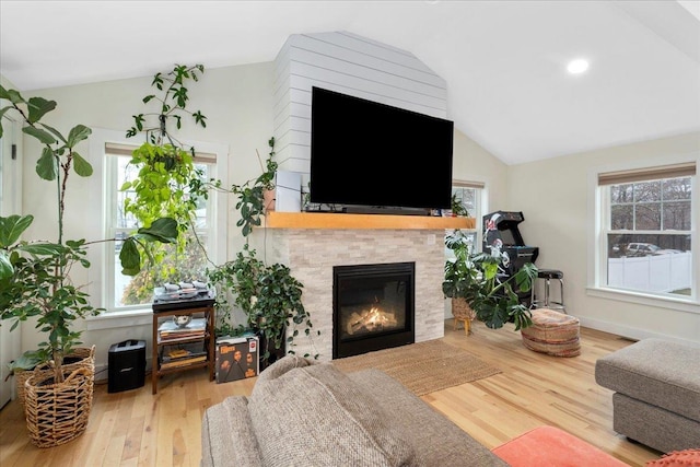 140 S Mast St, Goffstown, NH 03045 - living area with lofted ceiling, wood finished floors, a fireplace, and baseboards