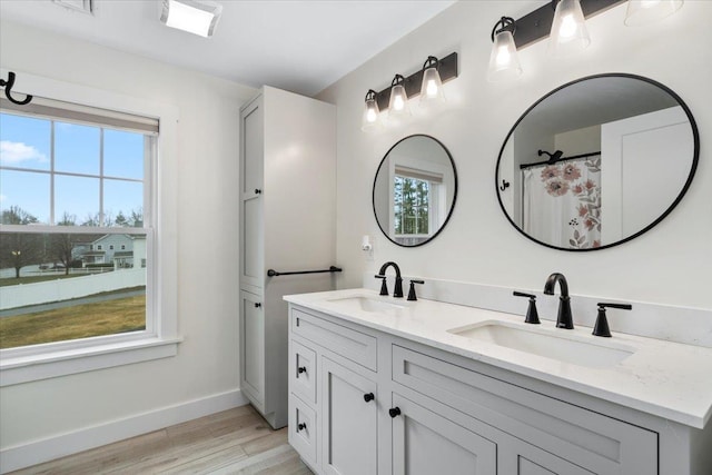 140 S Mast St, Goffstown, NH 03045 - bathroom with double vanity, wood finished floors, and baseboards