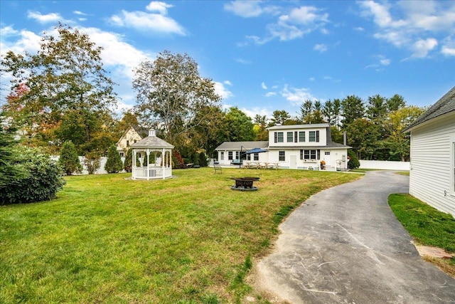 140 S Mast St, Goffstown, NH 03045 - view of front of home featuring a gazebo, a front yard, a fire pit, driveway, and view of scattered trees