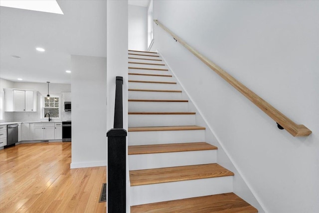 140 S Mast St, Goffstown, NH 03045 - stairway featuring recessed lighting, wood finished floors, and a skylight