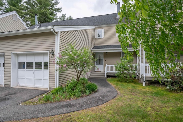 63 Winding Pond Rd, Londonderry, NH 03053 - view of front of property featuring a front lawn, roof with shingles, covered porch, an attached garage, and driveway
