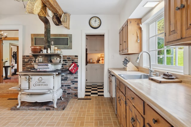 9671 Vt Route 12, Barnard, VT 05031 - kitchen with a sink, brick patterned floors, light countertops, stainless steel dishwasher, and brown cabinets
