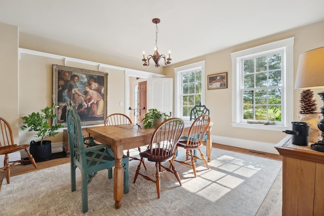 9671 Vt Route 12, Barnard, VT 05031 - dining space with a chandelier, light wood-style floors, and baseboards