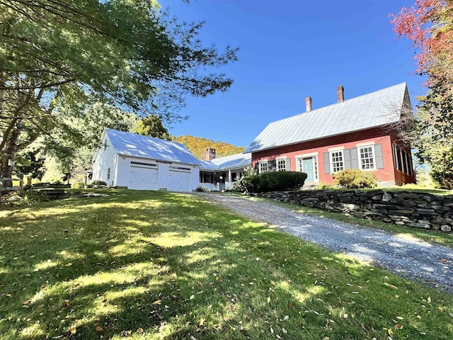 9671 Vt Route 12, Barnard, VT 05031 - view of front facade with a chimney, a front yard, asphalt driveway, and metal roof