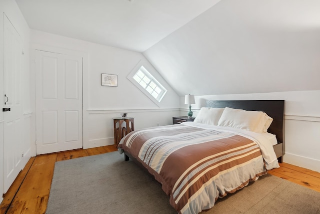 9671 Vt Route 12, Barnard, VT 05031 - bedroom featuring hardwood / wood-style floors, vaulted ceiling, a skylight, and baseboards