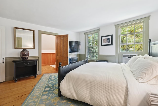 9671 Vt Route 12, Barnard, VT 05031 - bedroom featuring light wood finished floors, a wainscoted wall, ensuite bath, and cooling unit