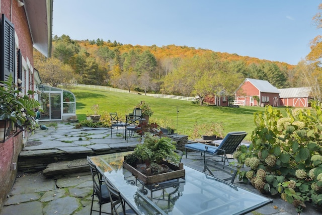 9671 Vt Route 12, Barnard, VT 05031 - view of patio / terrace featuring a forest view, a wooden deck, and outdoor dining area