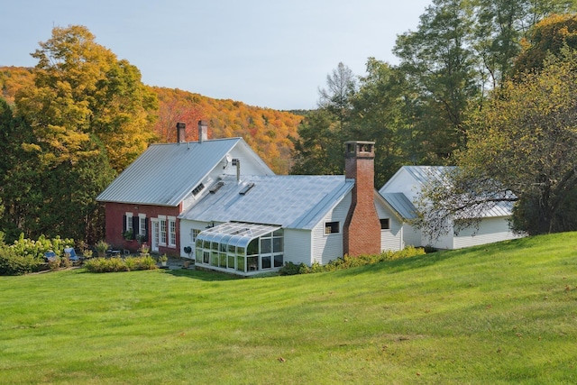 9671 Vt Route 12, Barnard, VT 05031 - rear view of property with a chimney, a sunroom, a yard, and metal roof