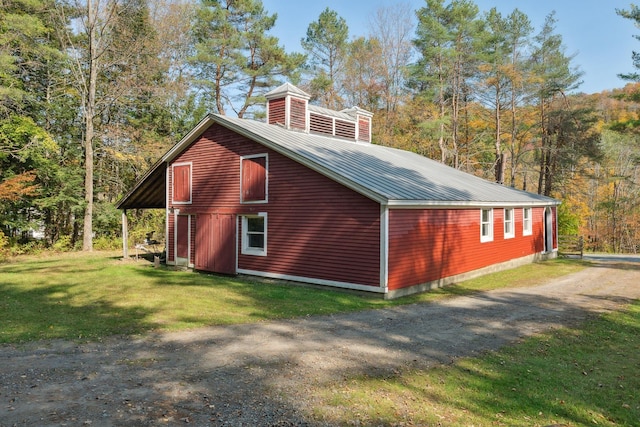 9671 Vt Route 12, Barnard, VT 05031 - view of side of property with a yard, metal roof, driveway, a chimney, and a view of trees