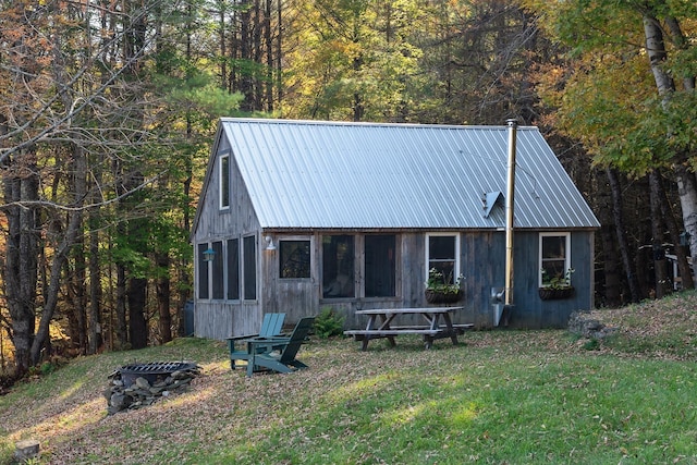 9671 Vt Route 12, Barnard, VT 05031 - rear view of property with a fire pit, metal roof, a lawn, and a wooded view