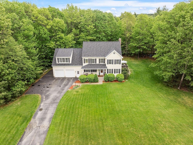 24 Stonewall Dr, Milford, NH 03055 - view of front facade featuring a chimney, asphalt driveway, covered porch, a garage, and a front yard