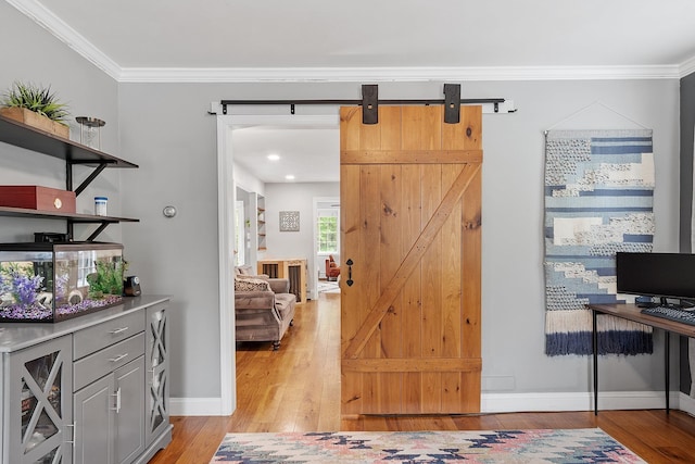 24 Stonewall Dr, Milford, NH 03055 - interior space with light wood-type flooring, crown molding, a barn door, and baseboards
