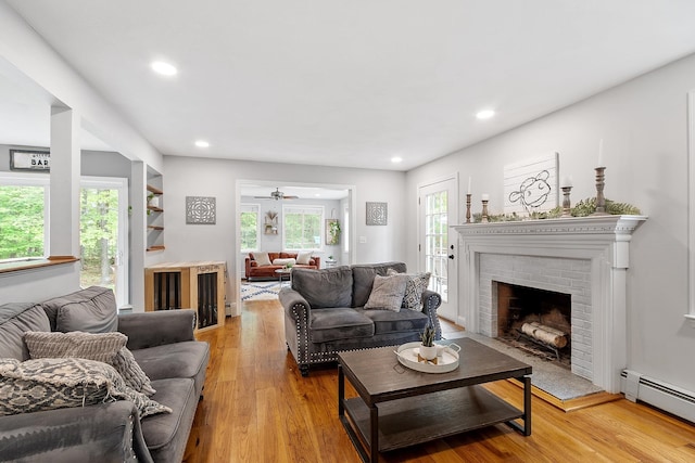 24 Stonewall Dr, Milford, NH 03055 - living area with baseboard heating, light wood-style flooring, a brick fireplace, and recessed lighting