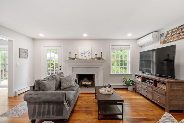 24 Stonewall Dr, Milford, NH 03055 - living room featuring a wall mounted AC, a baseboard radiator, plenty of natural light, light wood-style floors, and recessed lighting
