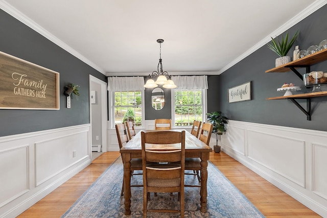 24 Stonewall Dr, Milford, NH 03055 - dining room featuring crown molding, a decorative wall, light wood-style floors, baseboard heating, and a chandelier