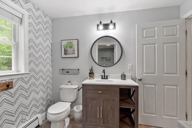 24 Stonewall Dr, Milford, NH 03055 - bathroom with a baseboard radiator, vanity, toilet, and an accent wall