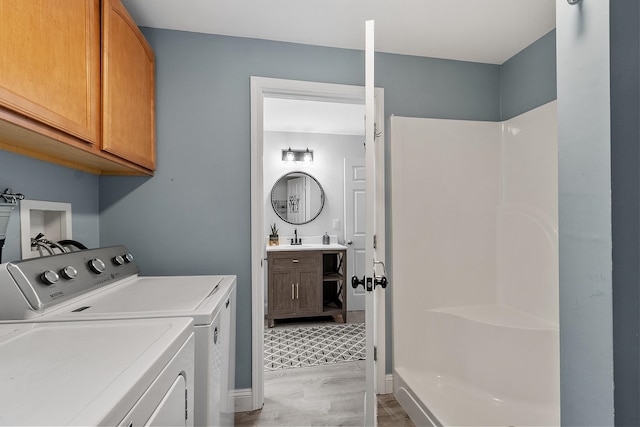 24 Stonewall Dr, Milford, NH 03055 - laundry area featuring cabinet space, light wood-style flooring, washing machine and dryer, and baseboards