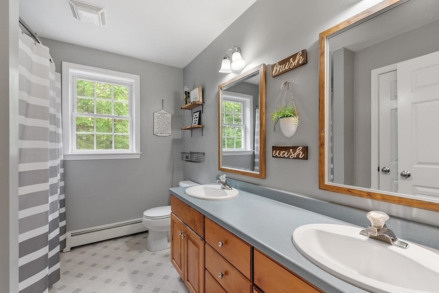 24 Stonewall Dr, Milford, NH 03055 - full bathroom featuring a baseboard heating unit, double vanity, and toilet
