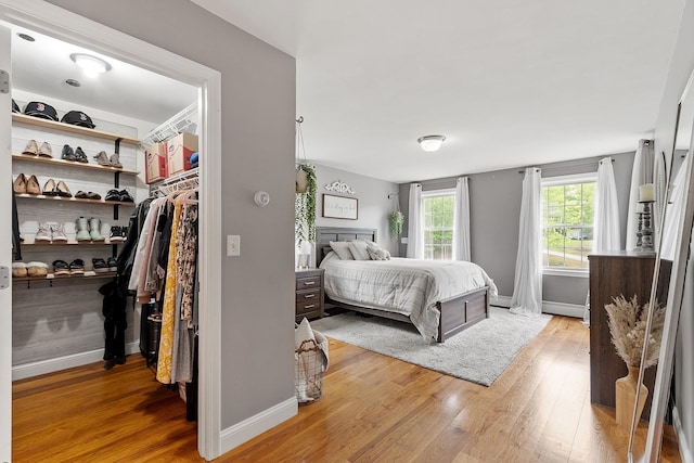 24 Stonewall Dr, Milford, NH 03055 - bedroom with light wood-style flooring, baseboards, and a walk in closet