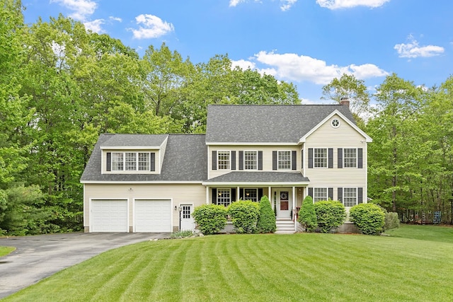 24 Stonewall Dr, Milford, NH 03055 - colonial home featuring asphalt driveway, a shingled roof, a chimney, and a front yard