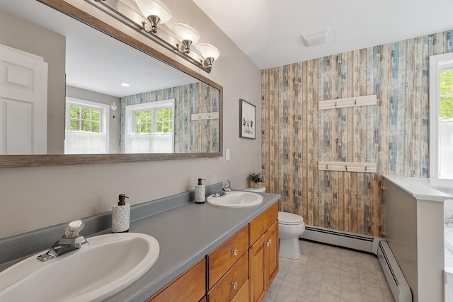 24 Stonewall Dr, Milford, NH 03055 - full bath with a baseboard heating unit, double vanity, and toilet