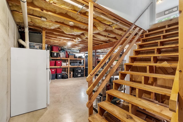 24 Stonewall Dr, Milford, NH 03055 - unfinished below grade area with freestanding refrigerator and stairway