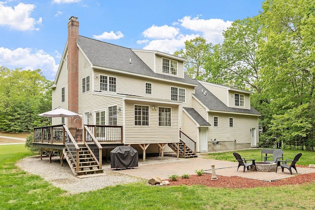 24 Stonewall Dr, Milford, NH 03055 - rear view of property with an outdoor fire pit, a deck, a patio area, a lawn, and stairway