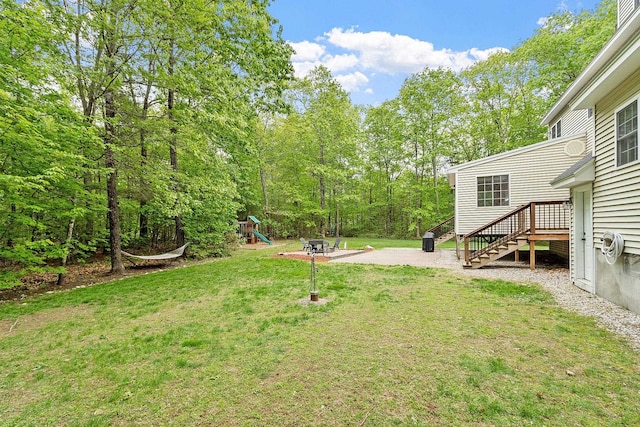 24 Stonewall Dr, Milford, NH 03055 - view of green lawn with a playground, stairs, and a patio area