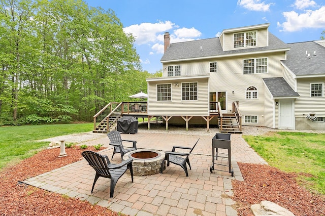 24 Stonewall Dr, Milford, NH 03055 - rear view of house featuring a fire pit, stairway, a patio area, a wooden deck, and roof with shingles